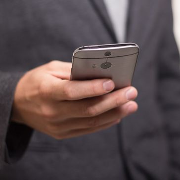 Guy in suit using phone